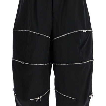 COMME DES GARCONS BLACK cropped pants with zip openings.