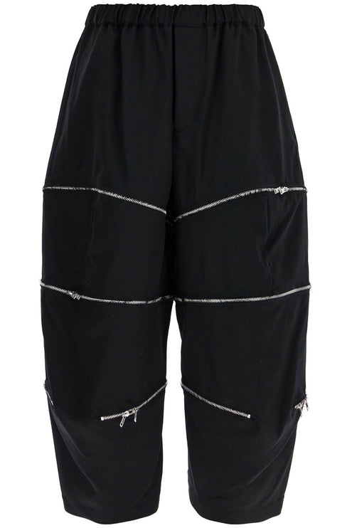 COMME DES GARCONS BLACK cropped pants with zip openings.