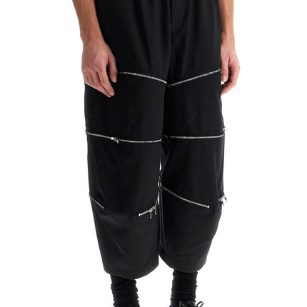 COMME DES GARCONS BLACK cropped pants with zip openings.