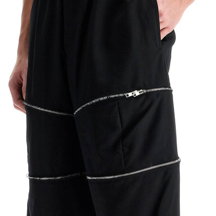 COMME DES GARCONS BLACK cropped pants with zip openings.