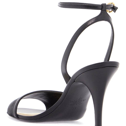 Valentino Garavani black goat leather sandals with gold buckle and stiletto heel