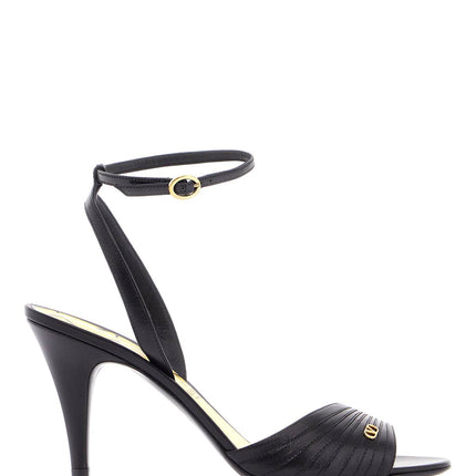 Valentino Garavani black goat leather sandals with gold buckle and stiletto heel