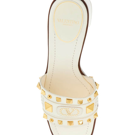 Valentino Garavani ivory leather slippers with golden studs and low heel