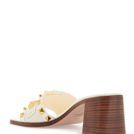 Valentino Garavani ivory leather slippers with golden studs and low heel